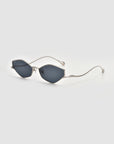 The For Art's Sake® Moment sunglasses feature a sleek silver metal frame with dark oval lenses and thin, curved arms, shown on a plain light grey background.