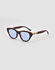 For Art's Sake® The Cuts cat-eye sunglasses feature blue-tinted lenses and 3D weaved metal gold chain arms, shown on a light gray background.