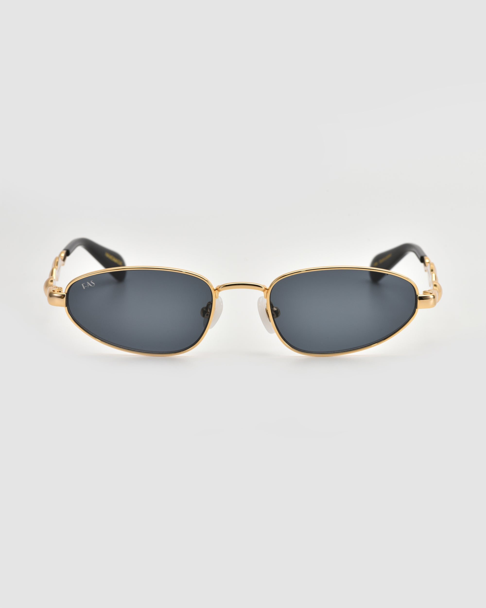 The For Art's Sake® Droplets sunglasses feature gold frames, dark rectangular lenses, and black temple arms—an eye-catching retro statement on a light gray background.