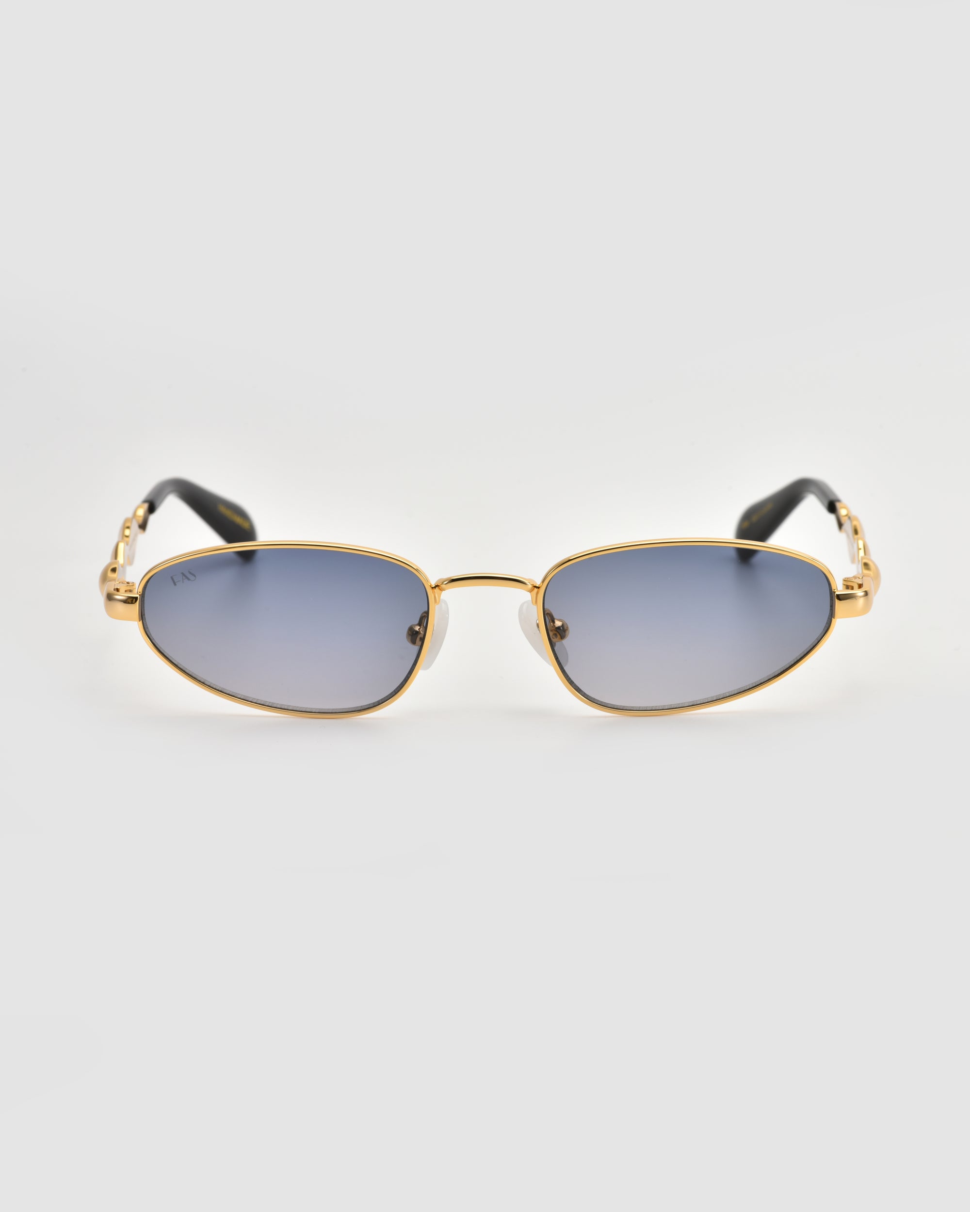 Droplets by For Art's Sake® feature gold metal frames, blue-tinted rectangular lenses, and black temple arms for a retro look, displayed on a light gray background.