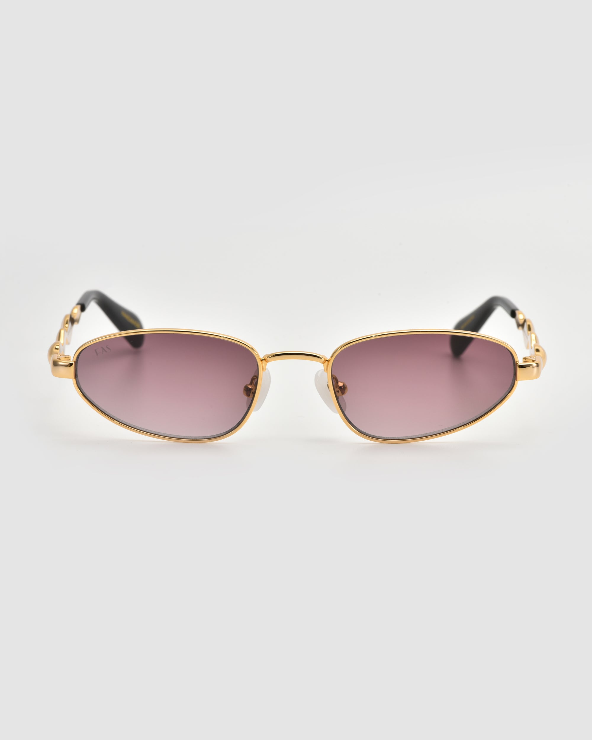 Droplets by For Art's Sake®: Gold-framed retro oval sunglasses with purple-tinted lenses and black arms, making a bold statement against a crisp white background.