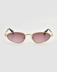 Droplets by For Art's Sake®: Gold-framed retro oval sunglasses with purple-tinted lenses and black arms, making a bold statement against a crisp white background.