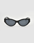 The For Art's Sake® Halo(S) black cat-eye sunglasses, featuring a sculptural acetate frame and dark lenses, are displayed facing forward on a plain light gray background.