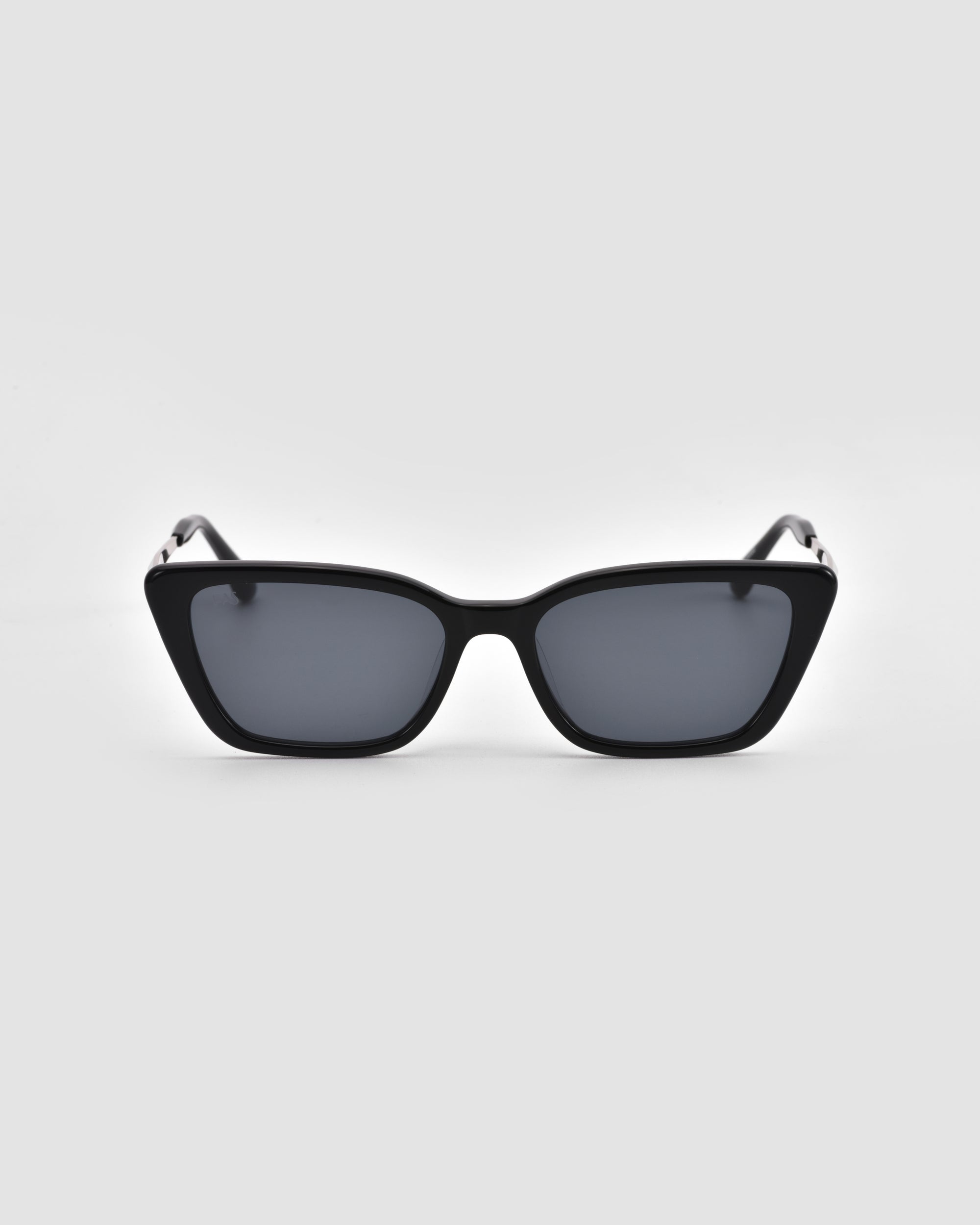 For Art's Sake® Harmony(S) black cat-eye sunglasses feature dark tinted lenses and a sculptural frame, displayed facing forward against a plain light gray background to showcase the full frame and both arms.