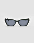 The Harmony(S) by For Art's Sake® are black, square minimal sunglasses with dark tinted lenses and a sculptural frame, shown on a plain light gray background.