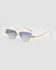 For Art's Sake® Florist: Square, rimless sunglasses with gradient blue lenses, slim gold arms, and decorative gold floral accents at the hinges. Elegant and unique against a plain light grey background.