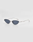 Lake cat-eye sunglasses by For Art's Sake® feature dark lenses, ultra-modern sculpted temples, and slim wavy silver metal arms, shown against a plain light gray background.