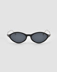 A pair of For Art's Sake® Totto black oval sunglasses with dark lenses and thin metal arms, featuring sculpted temples, shown on a plain light gray background.