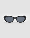 Tulip I by For Art's Sake®: black cat-eye sunglasses with a bold acetate front, dark lenses, and thin arms, shown on a plain light gray background.