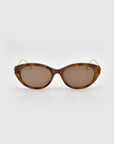 The Tulip I cat-eye sunglasses by For Art's Sake® feature a bold brown tortoiseshell acetate front, brown tinted lenses, and slim gold arms, showcased on a plain light gray background.