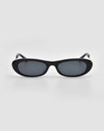Abstraction I by For Art's Sake®: Black chunky frame sunglasses with oval dark tinted lenses, shown against a plain light gray background.