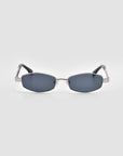 Mesa I sunglasses by For Art's Sake® feature dark lenses and silver metal frames in a sculptural design, shown facing forward on a light gray background.