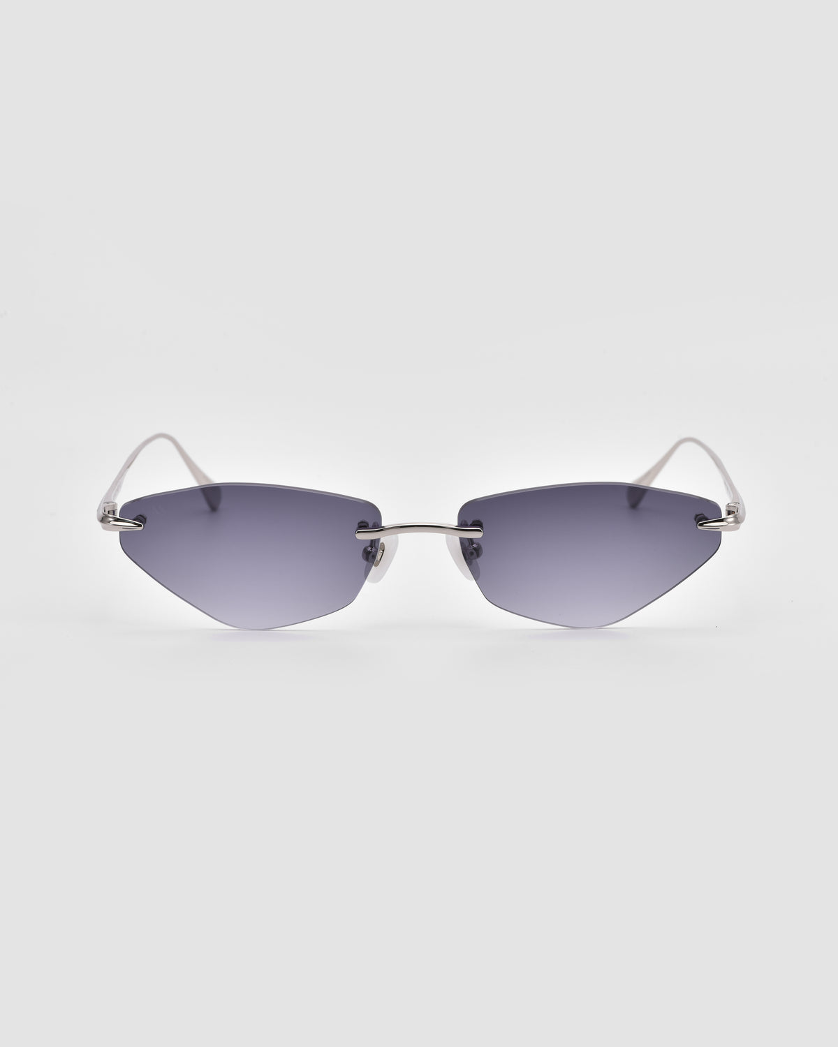 A pair of For Art’s Sake® Sienna I rimless sunglasses with dark, angular lenses and thin metal temples, featuring jade stone nose pads, displayed on a plain white background.
