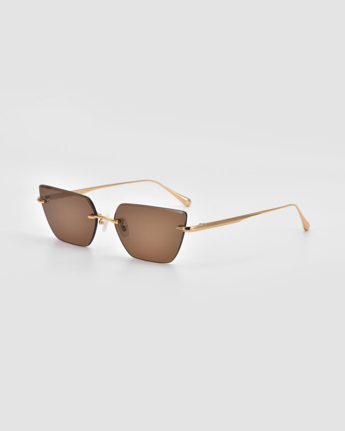 For Art’s Sake® Sienna II sunglasses with brown square lenses, thin gold metal frames, and jade stone nose pads are shown on a light gray background, angled to reveal both front and side views.