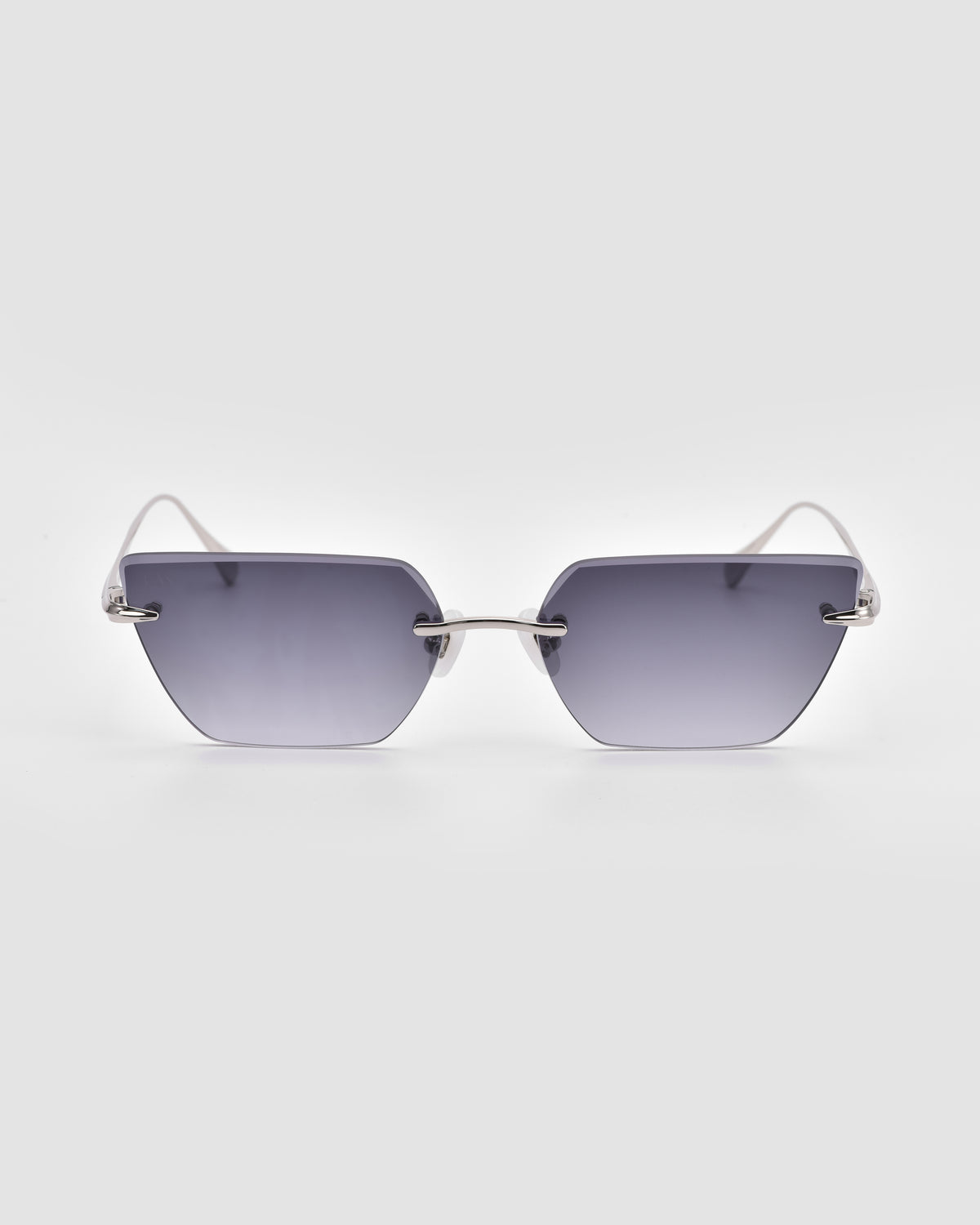 For Art’s Sake® Sienna II sunglasses with hexagonal, rimless dark gray gradient lenses, jade stone nose pads, and slim silver metal arms on a plain light gray background.