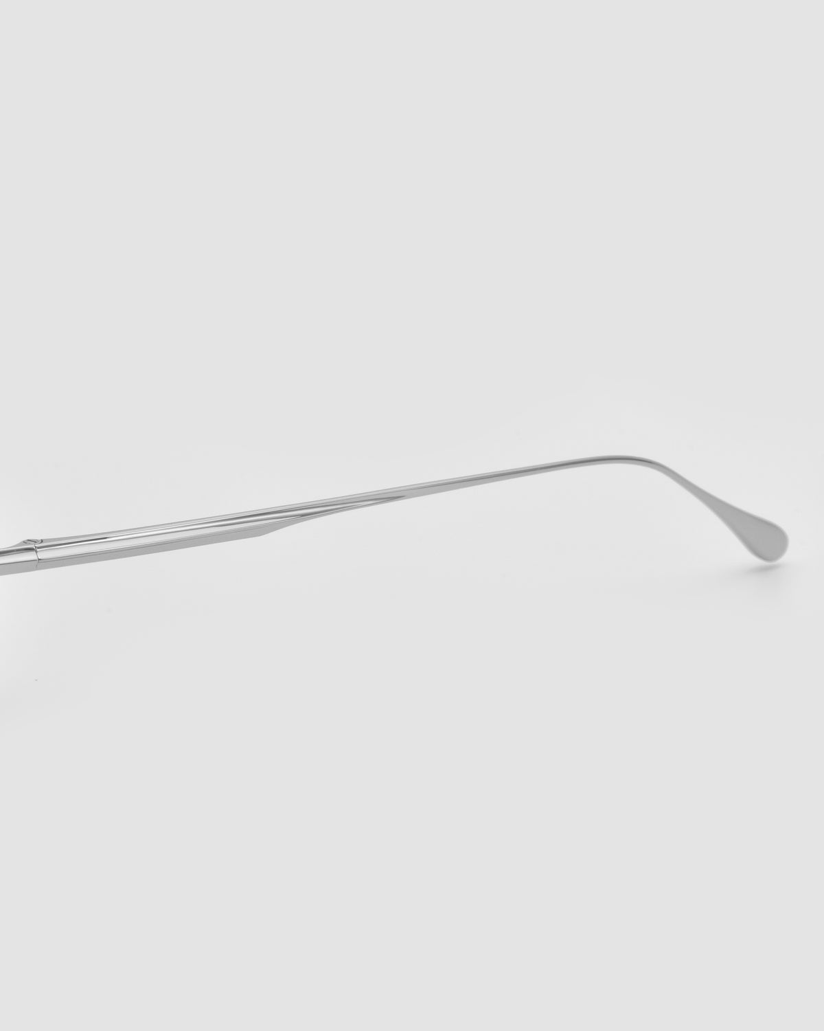 The Marisol II by For Art’s Sake® is a long-handled metal shoehorn with sculpted detailing, shown horizontally on a plain white background.