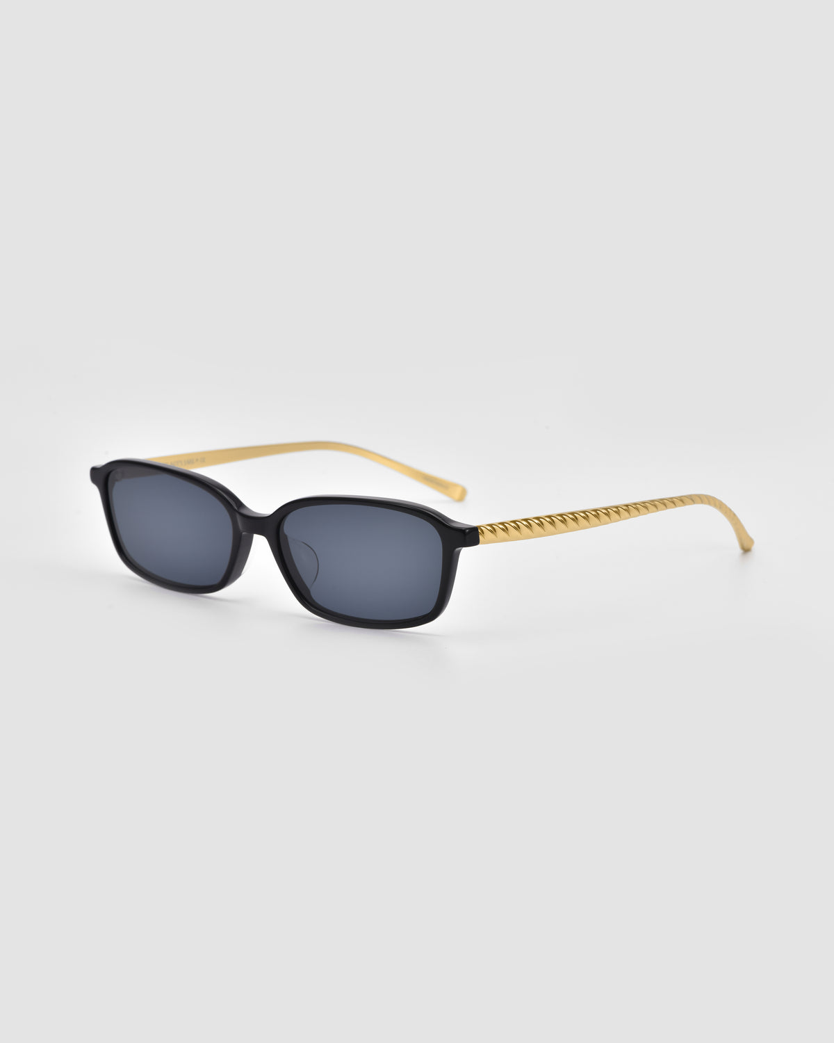 Solana I by For Art’s Sake®: rectangular sunglasses with black frames, dark lenses, and thin gold zigzag arms—sleek, modern style designed for lightweight comfort on a light gray background.