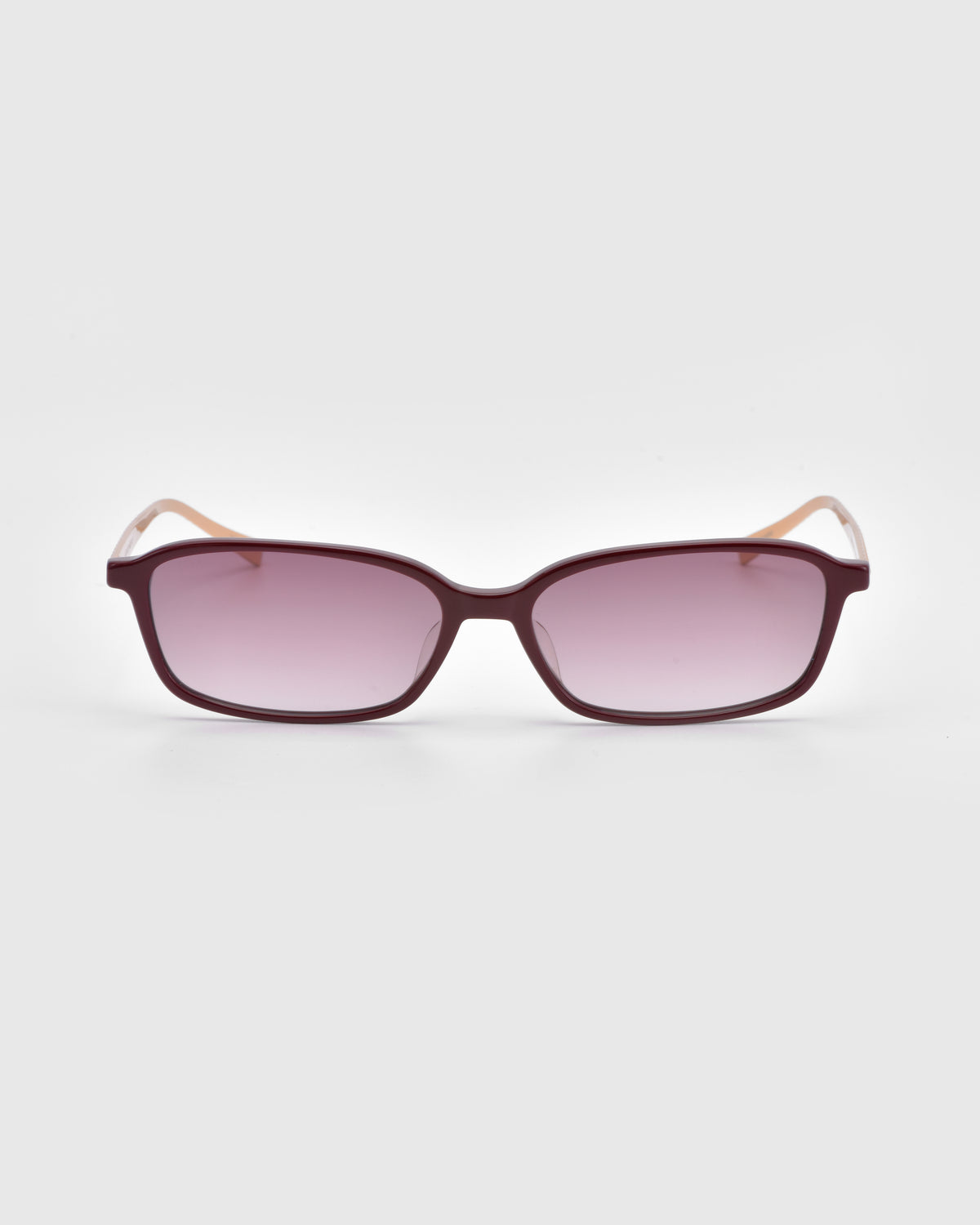 Solana I by For Art’s Sake® features modern rectangular sunglasses with dark purple frames, light pink gradient lenses, and light beige arms; shown on a white background for statement style and comfort.