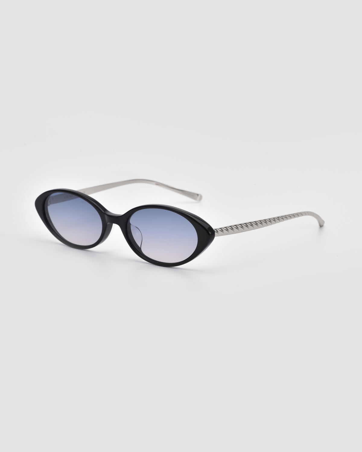 The Solana II by For Art’s Sake® features black oval acetate frames, blue-tinted lenses, and silver arms—bold sunglasses showcased against a plain white background.