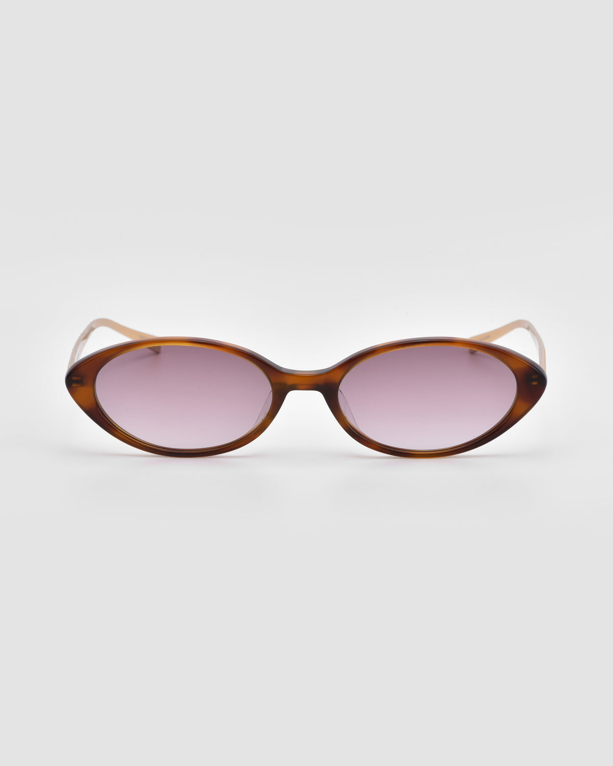 Solana II by For Art’s Sake®: Oval acetate sunglasses with brown tortoiseshell frames and light pink tinted lenses, shown on a plain white background.