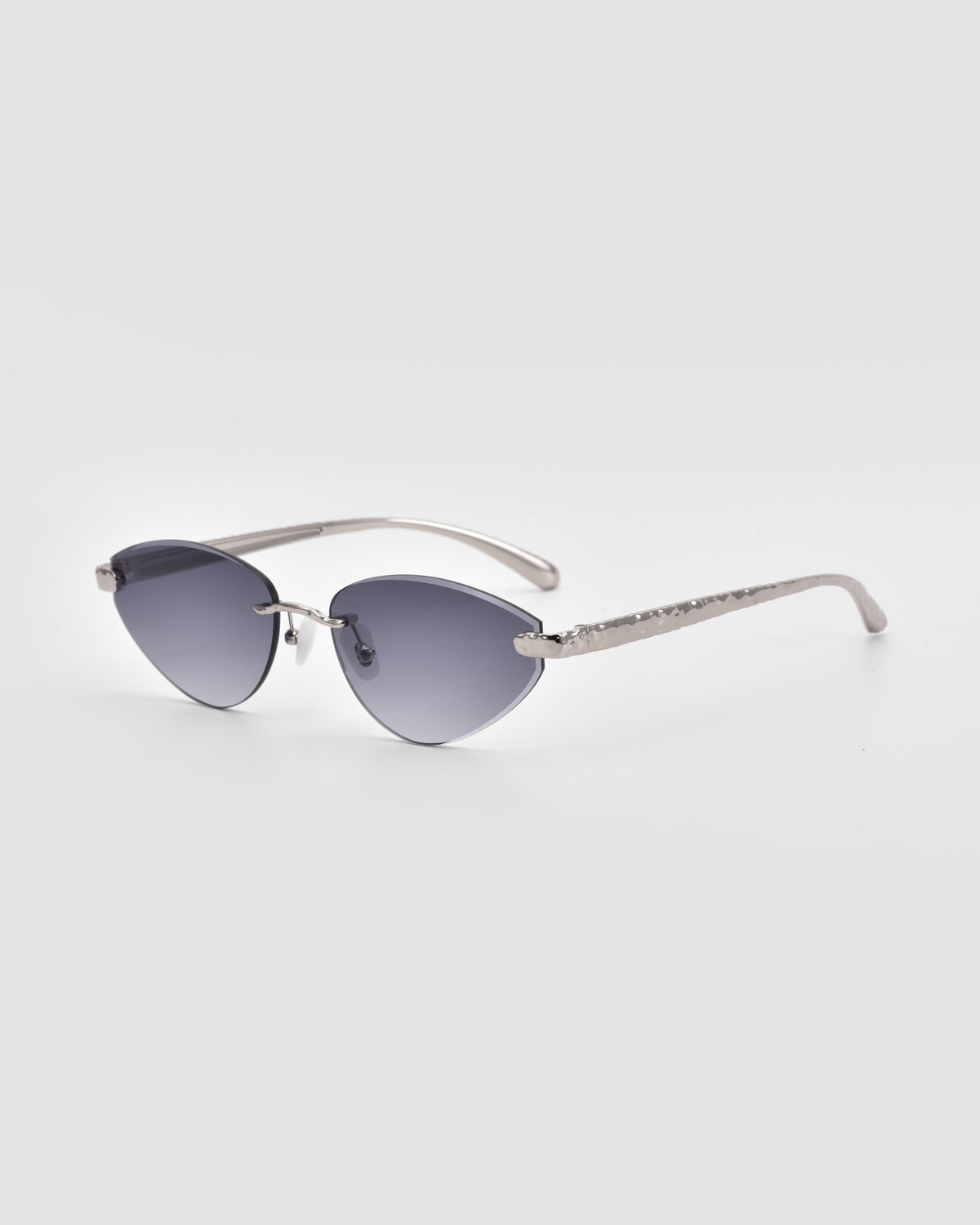 Shimmer I by For Art’s Sake®—cat-eye sunglasses with bevel-cut silver frames and gradient dark lenses—displayed on a plain light gray background.