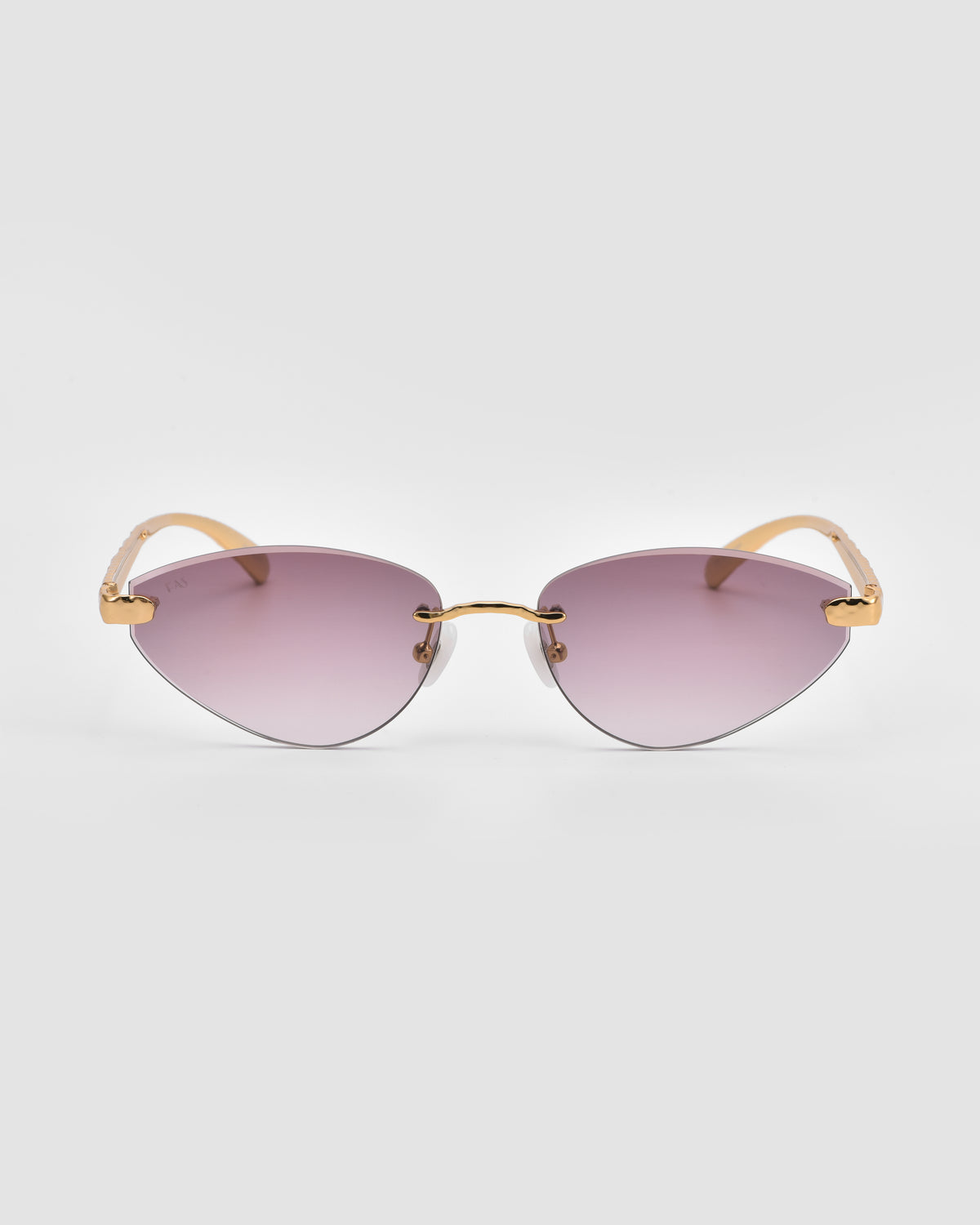 Shimmer I by For Art’s Sake® are cat-eye rimless sunglasses with gold temples, a slim gold bridge, and bevel-cut gradient purple lenses, shown on a plain light gray background.