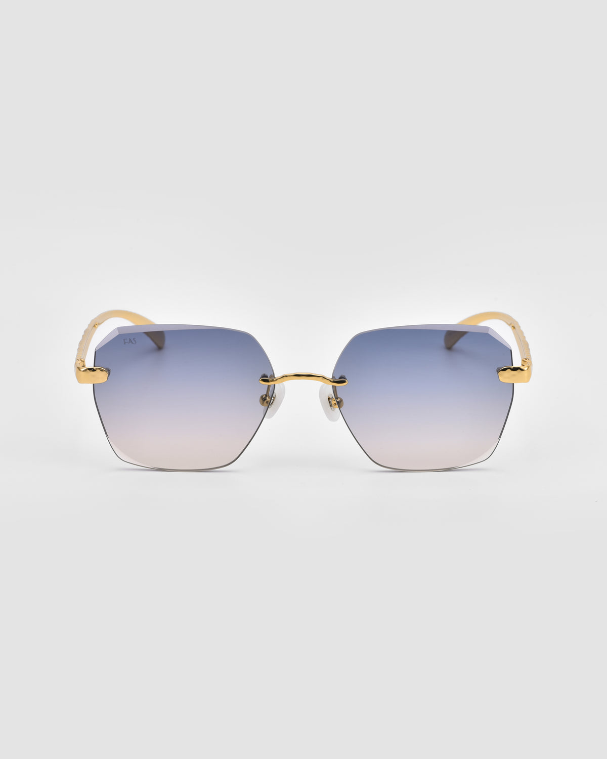 For Art’s Sake® Shimmer II sunglasses feature a rimless square silhouette, gold jewellery-inspired temples, and blue gradient lenses, shown on a plain light grey background.