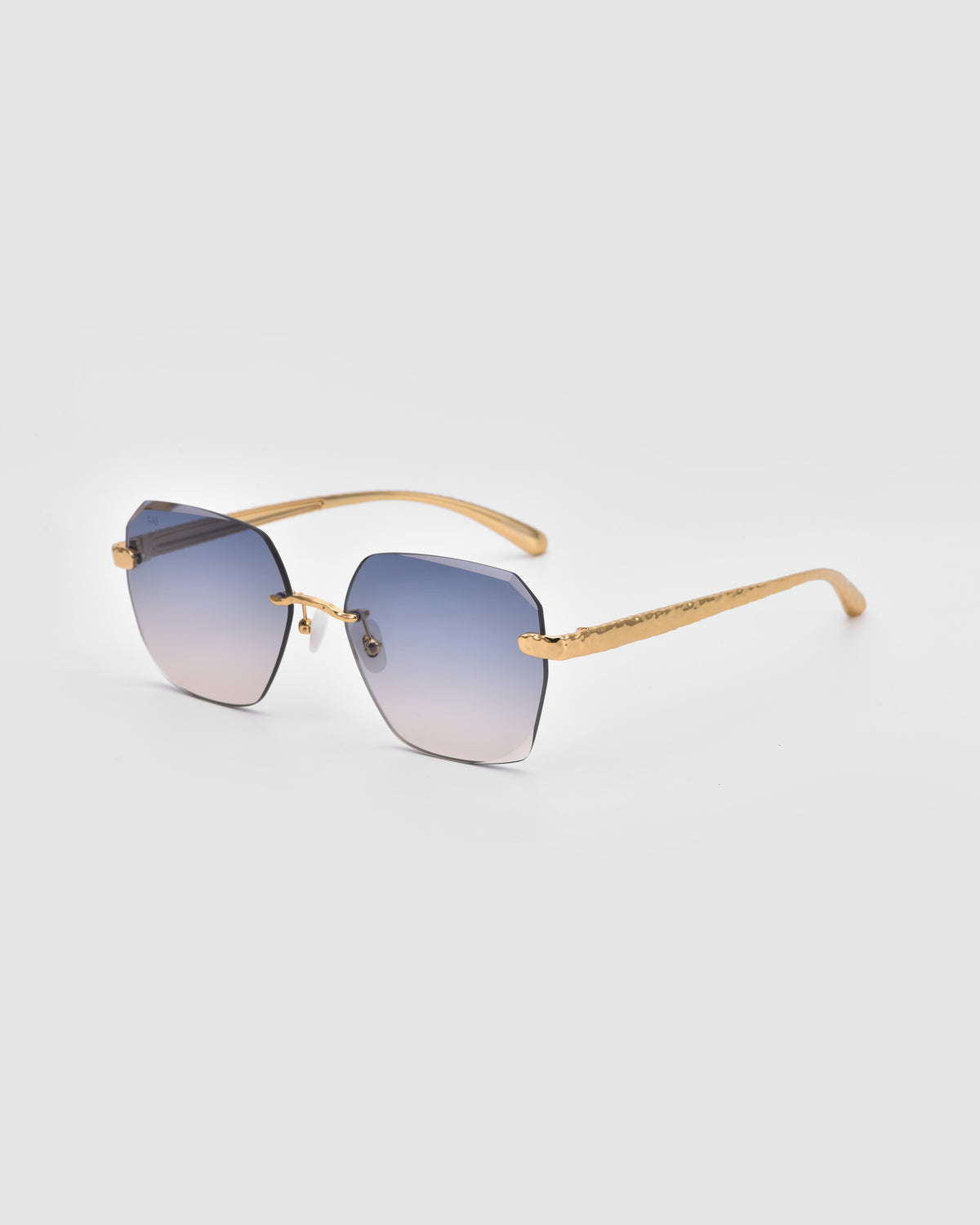 Shimmer II by For Art’s Sake®: gold-rimmed sunglasses with jewelry-inspired temples and square gradient blue bevel-cut lenses, shown on a light gray background.