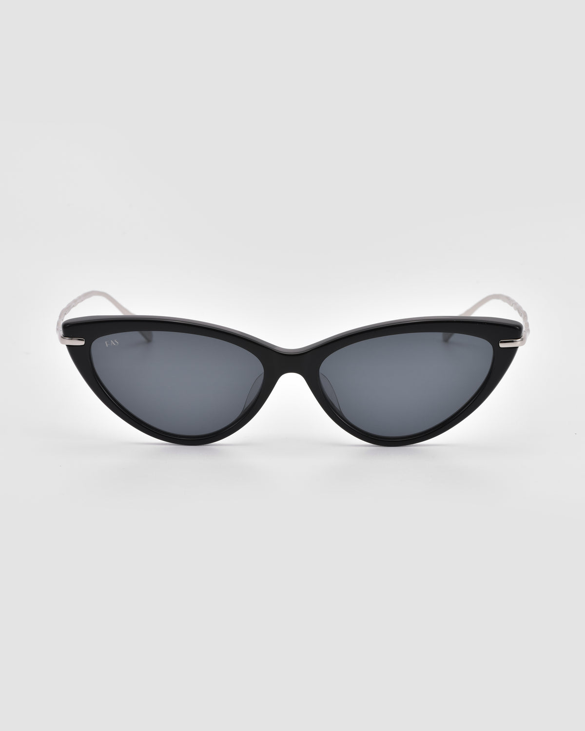 The Aurora sunglasses by For Art’s Sake® feature a cat-eye shape, dark lenses, and slim sculpted metal temples, displayed on a light gray background.