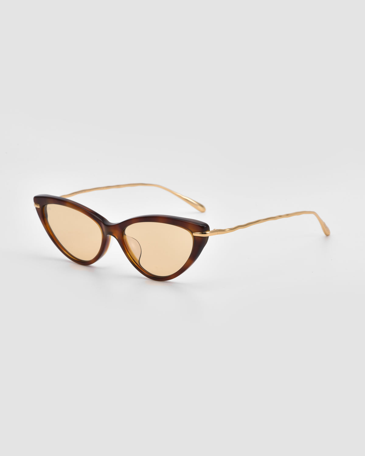 For Art’s Sake® Aurora sunglasses in brown feature a cat-eye silhouette, gold sculpted metal temples, and light brown tinted lenses, shown against a plain white background.