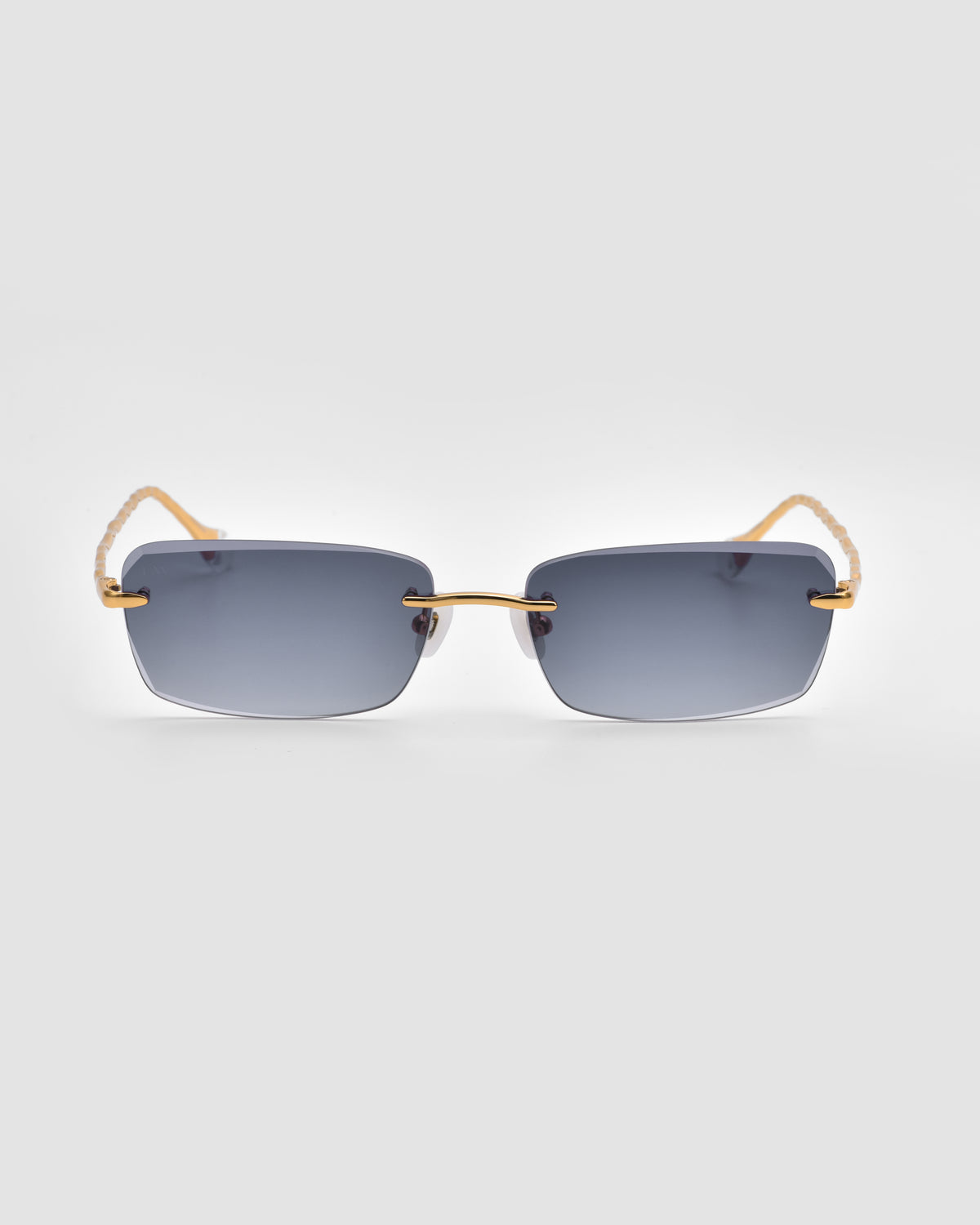 Sol I by For Art’s Sake®: rimless, rectangular Translucent Jewel sunglasses with dark gray lenses and thin gold temples with sculpted nylon tips, shown on a plain light gray background.