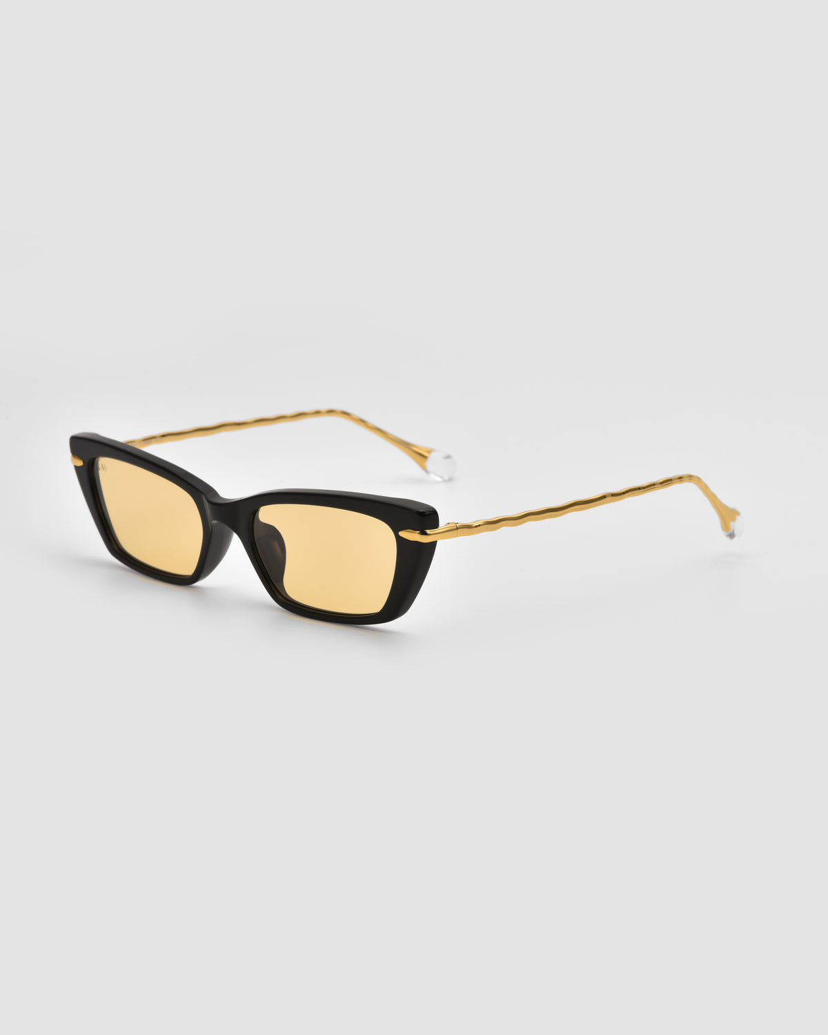 For Art’s Sake® Sol II sunglasses feature black rectangular frames, yellow-tinted lenses, and slim gold metal temples. Displayed on a light gray background, they capture the modern style of the Sol State collection.