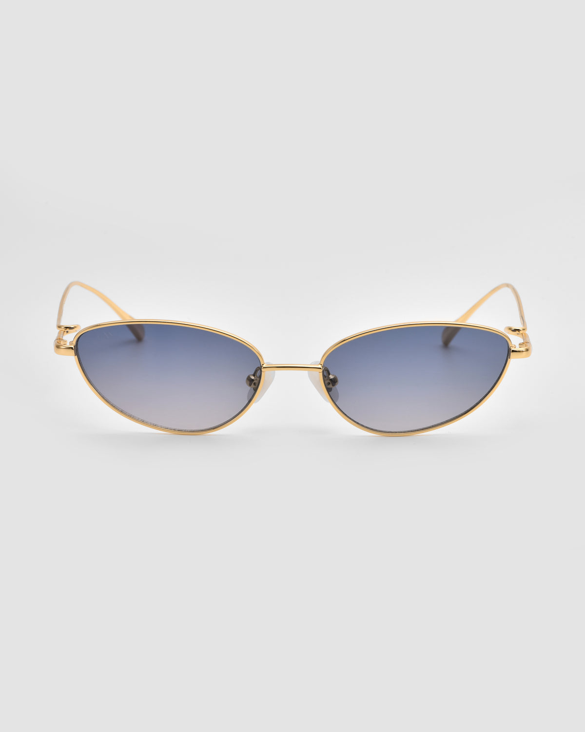 Ozanne I by For Art’s Sake®: gold-framed cat-eye sunglasses with gradient blue lenses, jewellery-inspired and displayed on a plain light gray background.