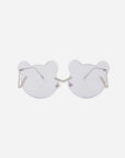 A pair of Teddy sunglasses by For Art's Sake® with lenses shaped like bear heads. The thin, metallic stainless steel frames and adjustable nosepads ensure a comfortable fit. The light, translucent shade offers UV protection, making the overall design playful and whimsical yet functional.