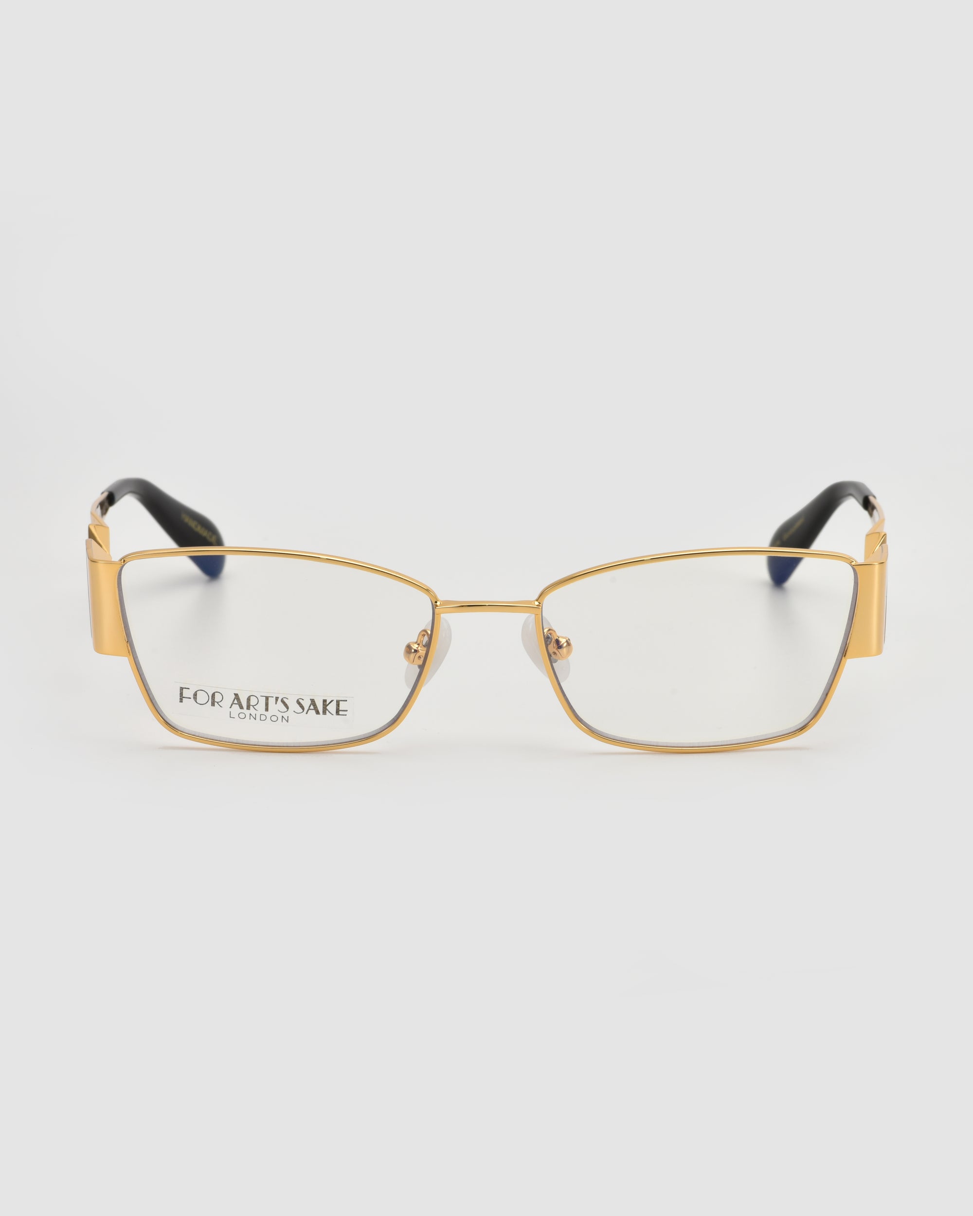 The Origami by For Art's Sake® are rectangular gold-rimmed eyeglasses with clear lenses, black temple tips, and a soft-square silhouette. "FOR ART'S SAKE LONDON" is printed on the left lens. Displayed on a white background.
