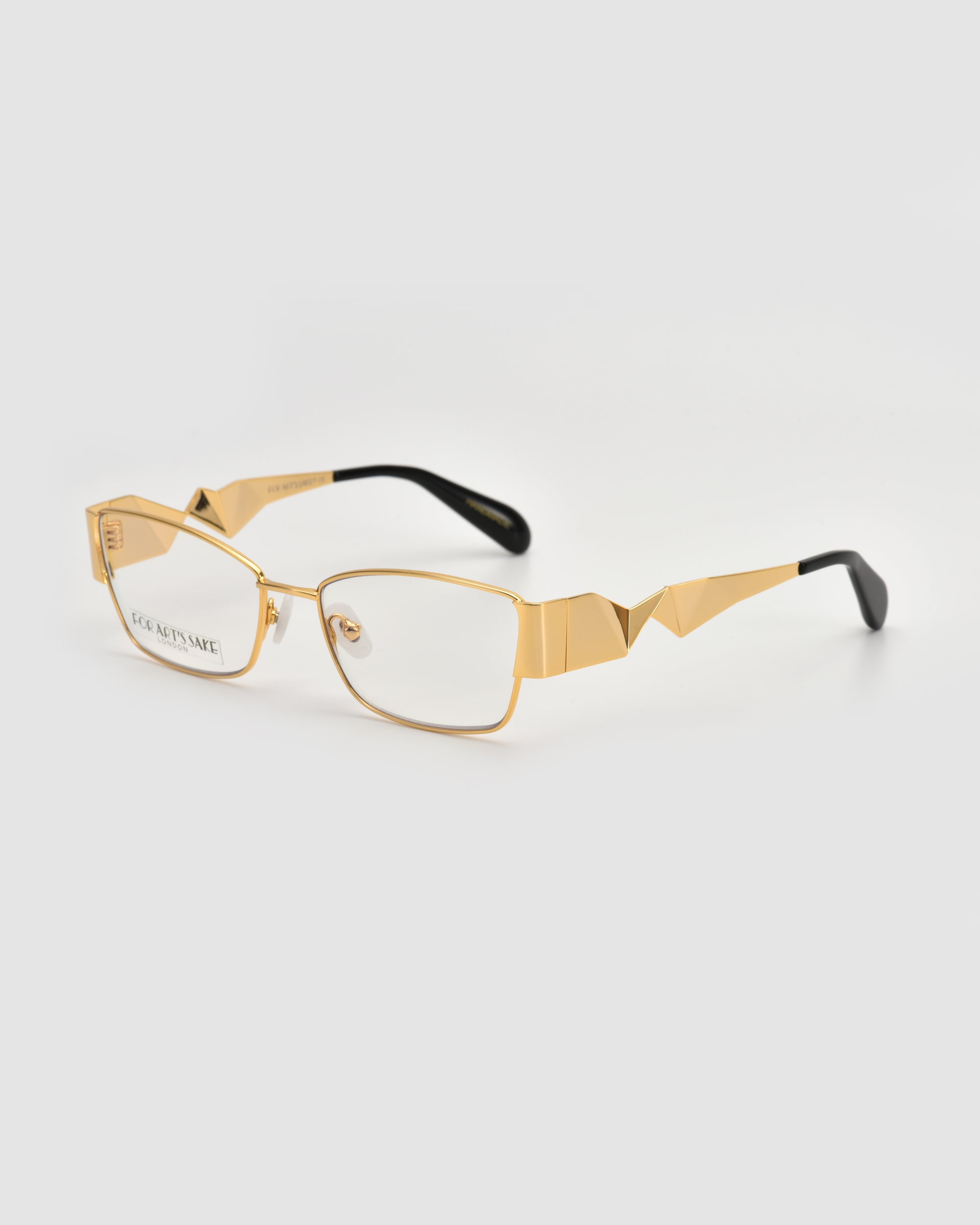 For Art's Sake® Origami eyeglasses feature a gold rectangular frame with a soft-square silhouette, geometric angular temple designs, and black-tipped arms, shown on a plain white background.