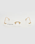 Waver rimless oval glasses by For Art's Sake®, featuring gold metal arms and bridge, are displayed on a plain white background with “For Art’s Sake London” in black on the left lens.