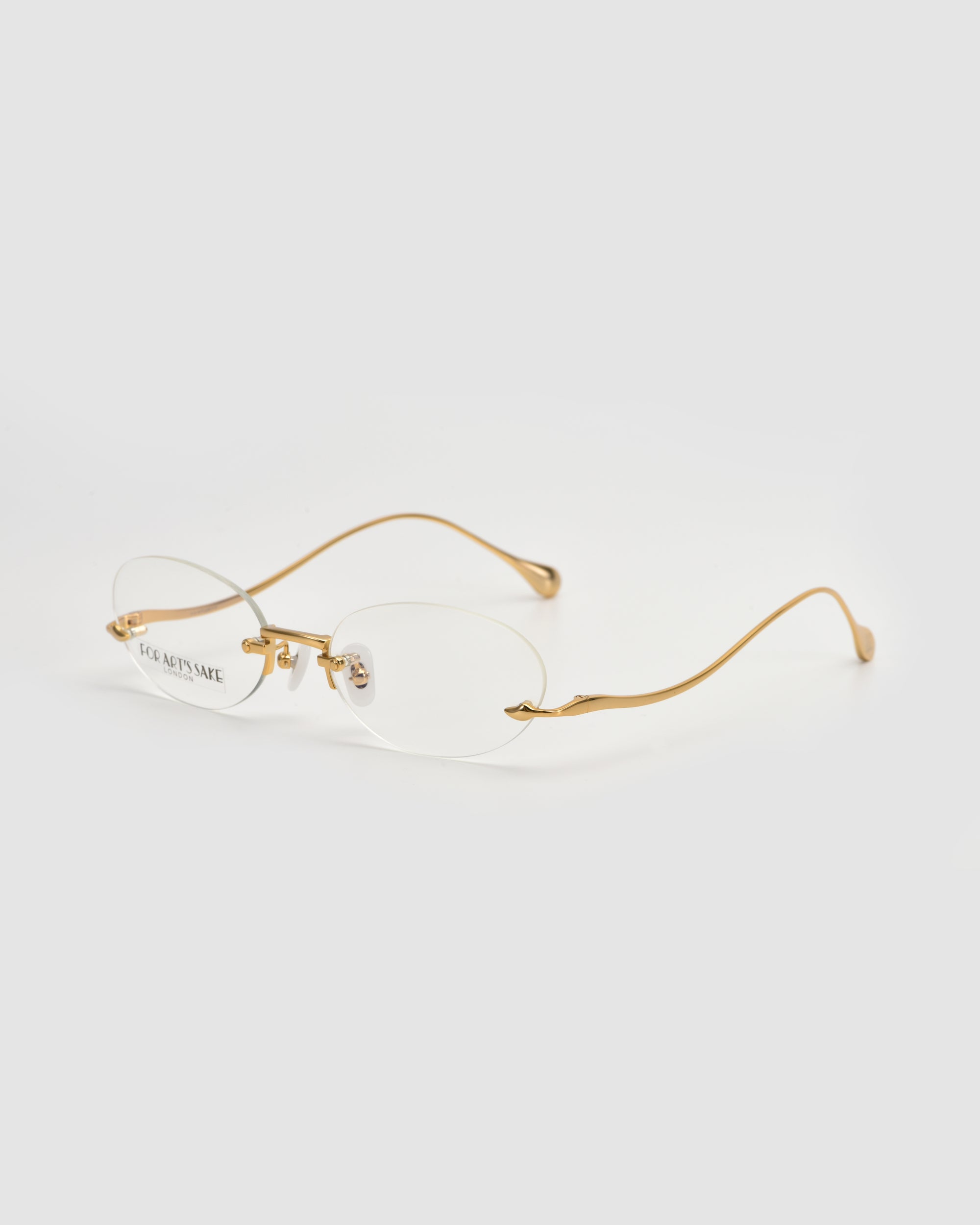 The Waver by For Art's Sake® features minimalistic rimless oval frames with thin gold metal temples, showcased against a white background.