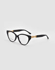 The Act by For Art's Sake®: black cat-eye eyeglasses with gold accents on the arms and a lightweight frame, shown on a light grey background.