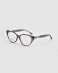 The Act by For Art's Sake® are translucent gray, round eyeglasses with lightweight frames and decorative metal temple accents, shown on a light gray background.