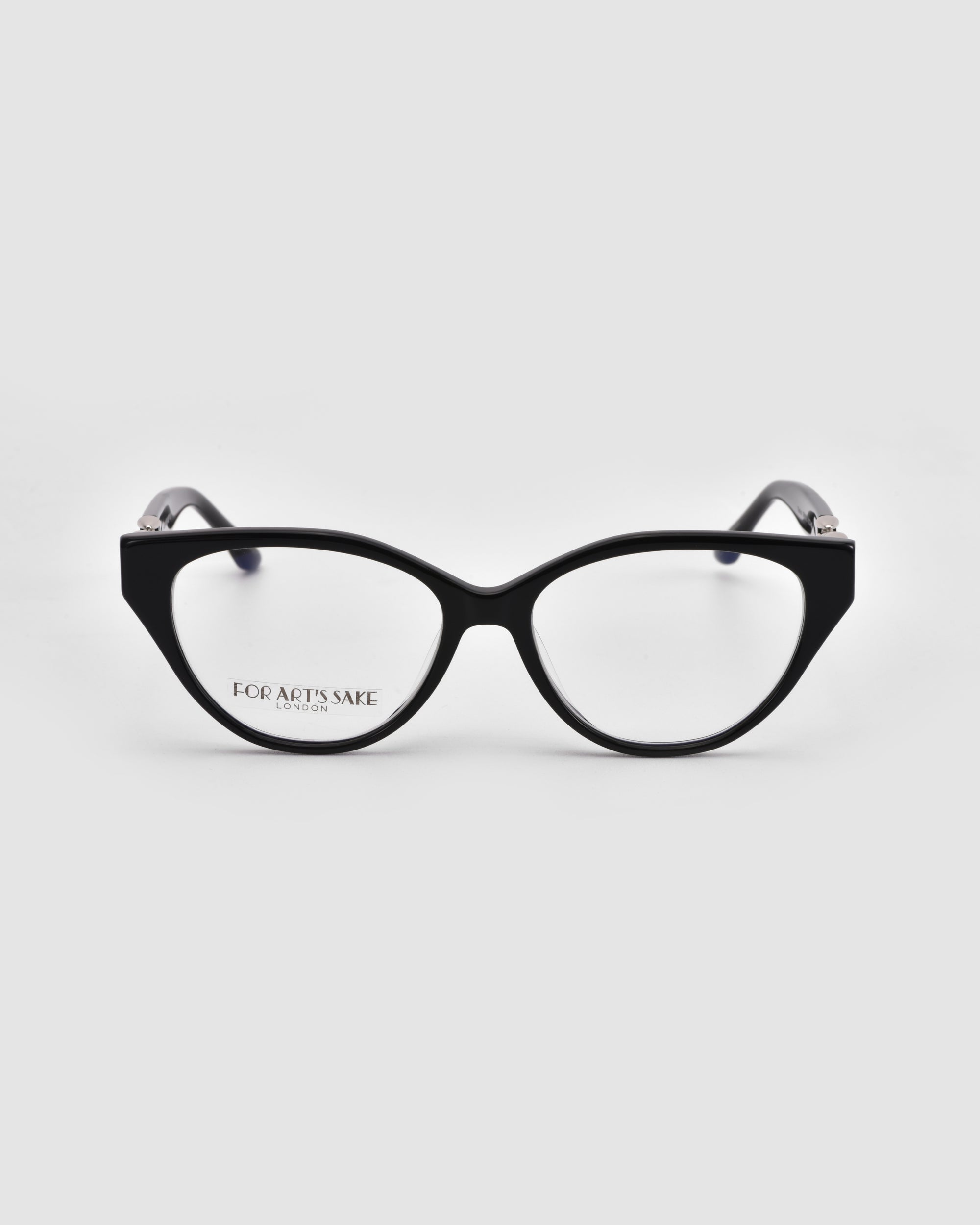 The Act cat-eye eyeglasses by For Art's Sake® feature black frames, clear lenses, and a lightweight design. Shown facing forward on a light gray background, the left lens is etched with "FOR ART’S SAKE.