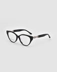 The Act by For Art's Sake® features black cat-eye eyeglasses with silver chain detailing on the temples, offering a minimalist yet chic look. Displayed against a light gray background.
