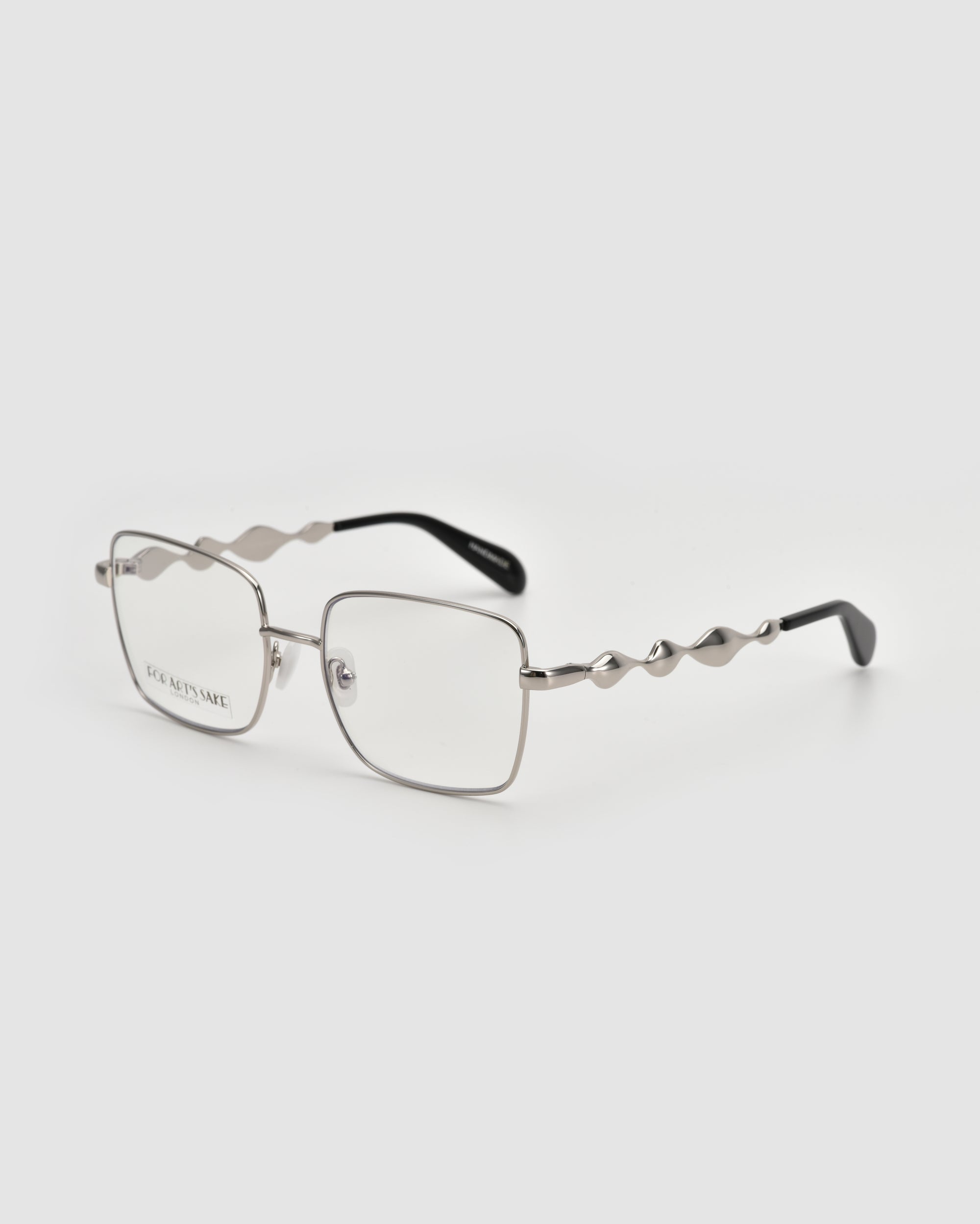Fluid by For Art's Sake®: Silver metal eyeglasses with a soft-square shape and wavy 3D fluid temples with black tips, shown on a white background.