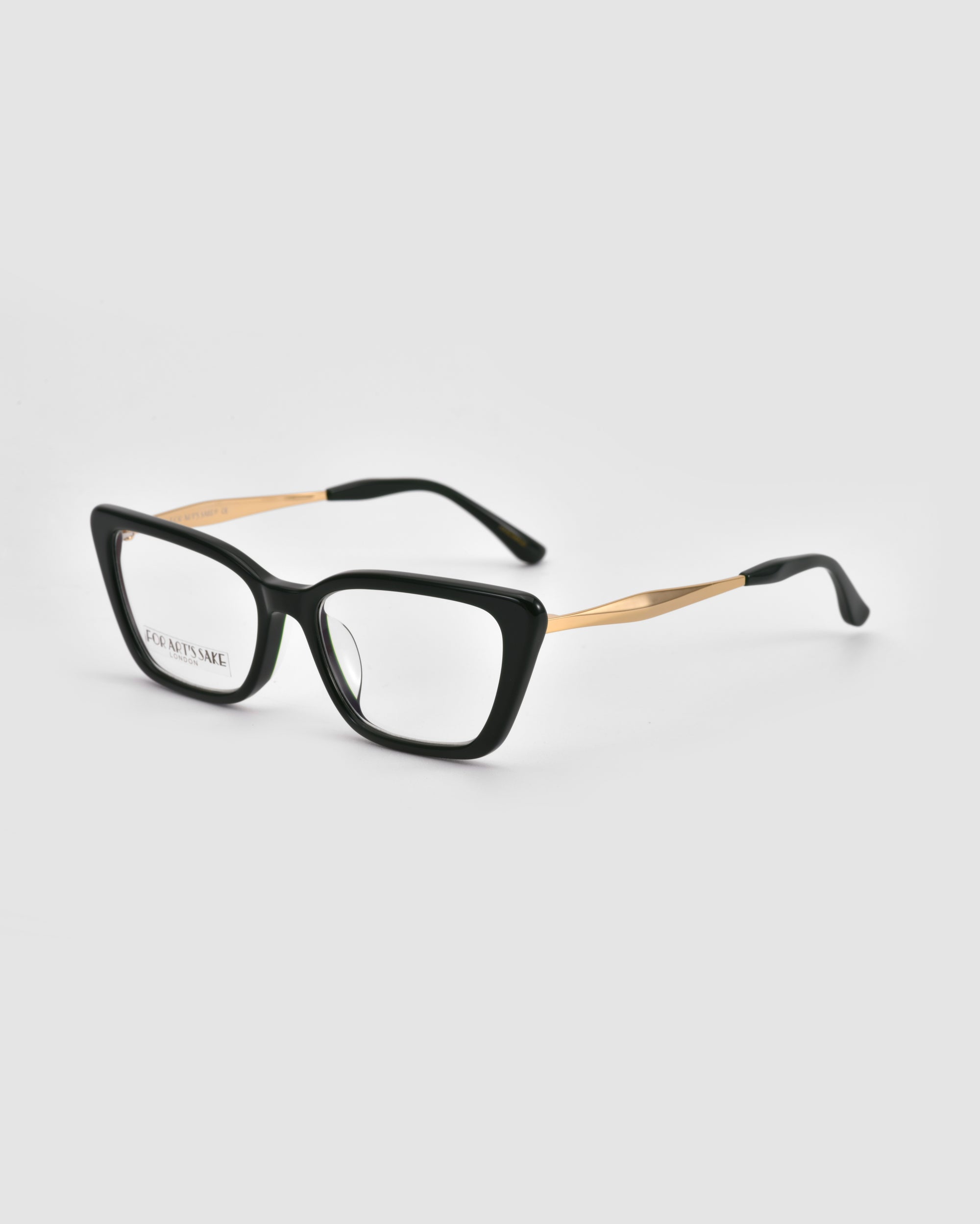 Harmony(X) eyeglasses by For Art's Sake® feature black square frames and sculptural gold metal temples, shown on a light gray background.