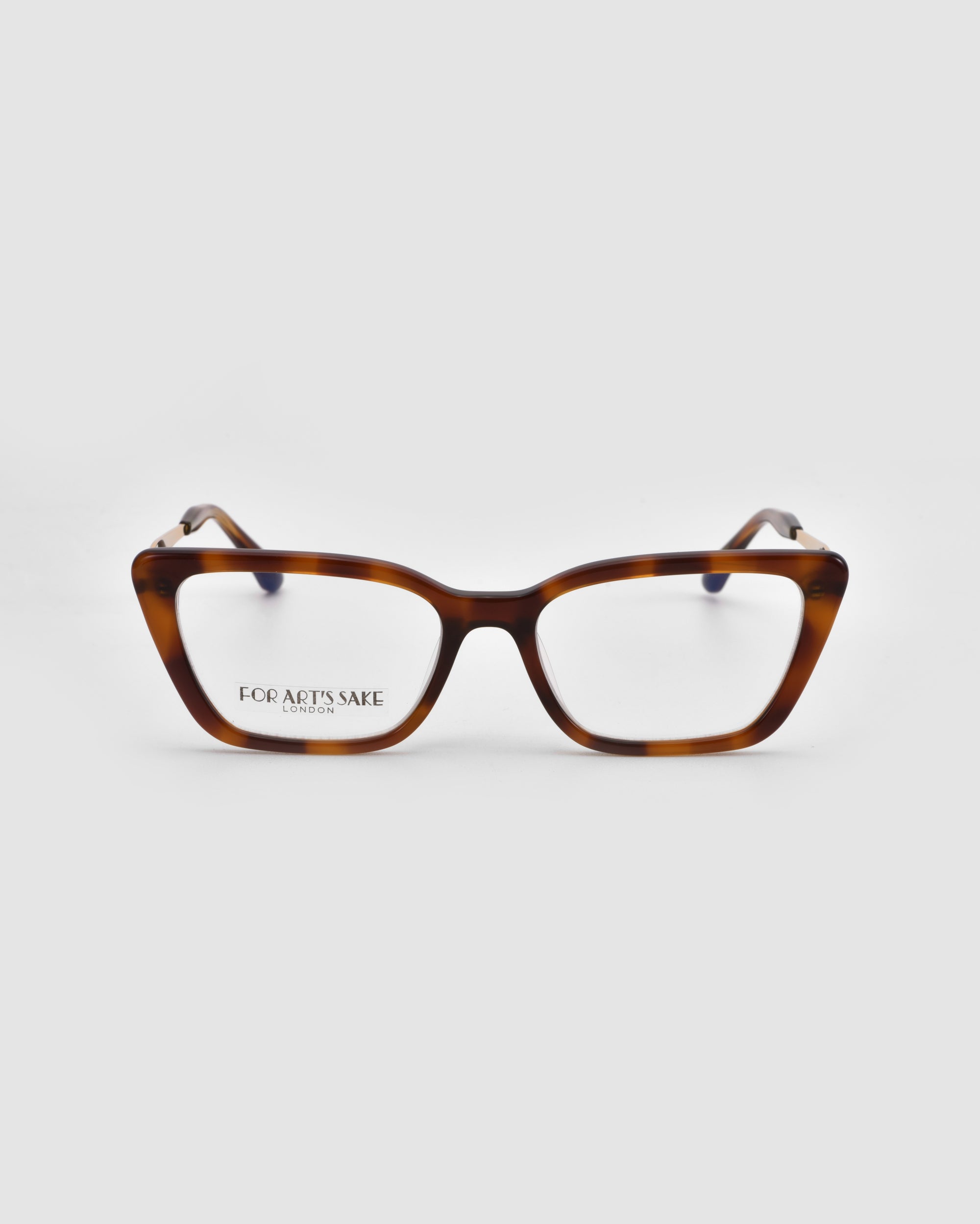The Harmony(X) cat-eye eyeglasses by For Art's Sake® feature a brown tortoiseshell boxy silhouette and clear lenses. Shown from the front on a white background, the inner frame displays "FOR ART'S SAKE" and additional small text.