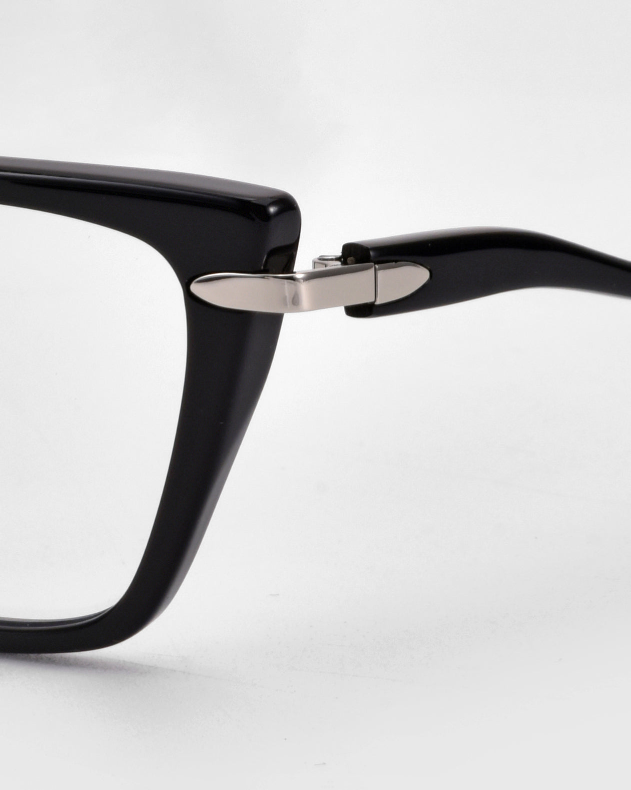 Close-up of For Art&#39;s Sake® Motion I eyeglasses, highlighting the black frame, hinge, and acetate temples with a sleek metal accent, set against a plain light background.