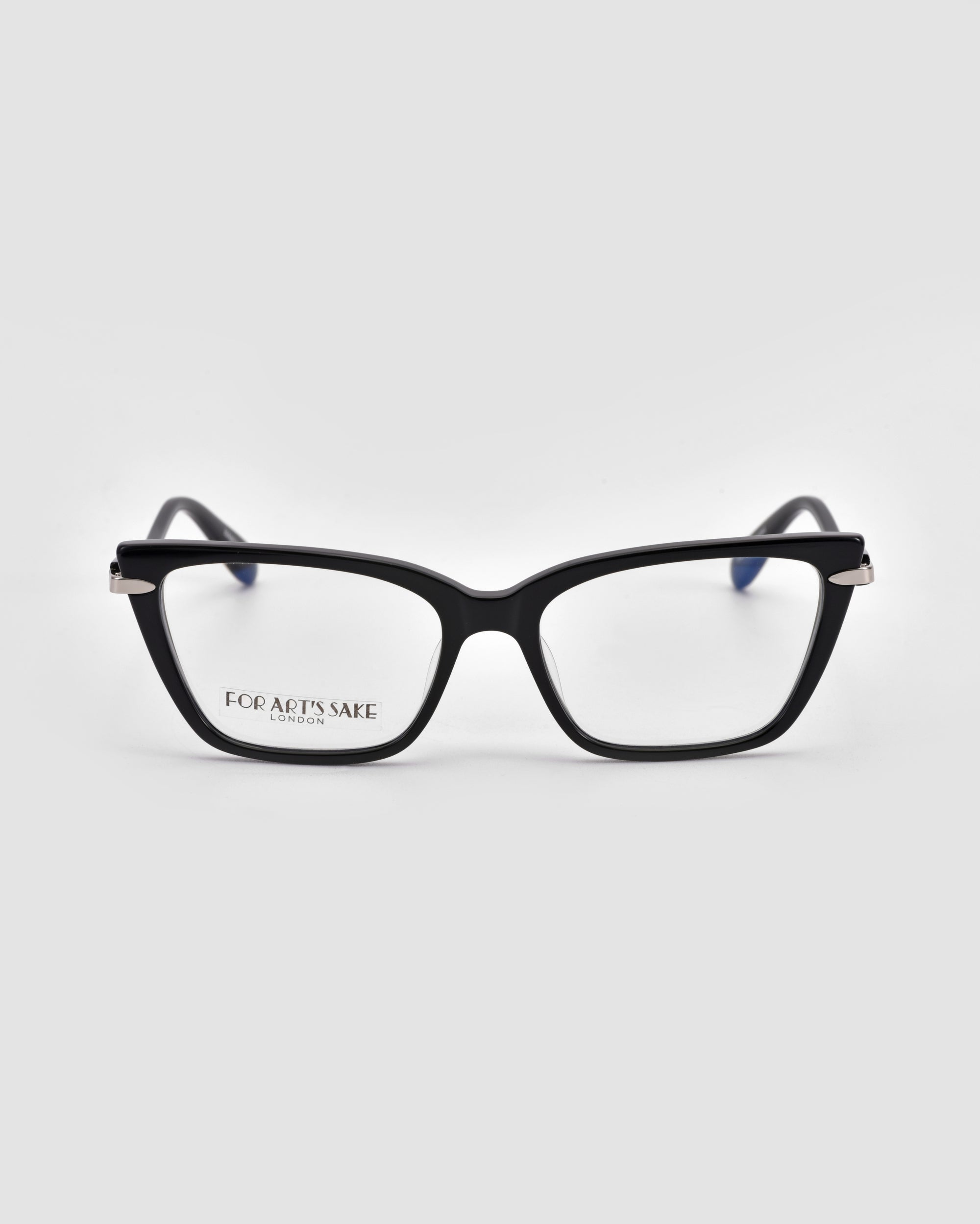 The For Art's Sake® Motion I is a pair of black rectangular eyeglasses with clear lenses and subtle metal accents, shown from the front on a plain light gray background. The inside of the left lens reads "FOR ART'S SAKE.