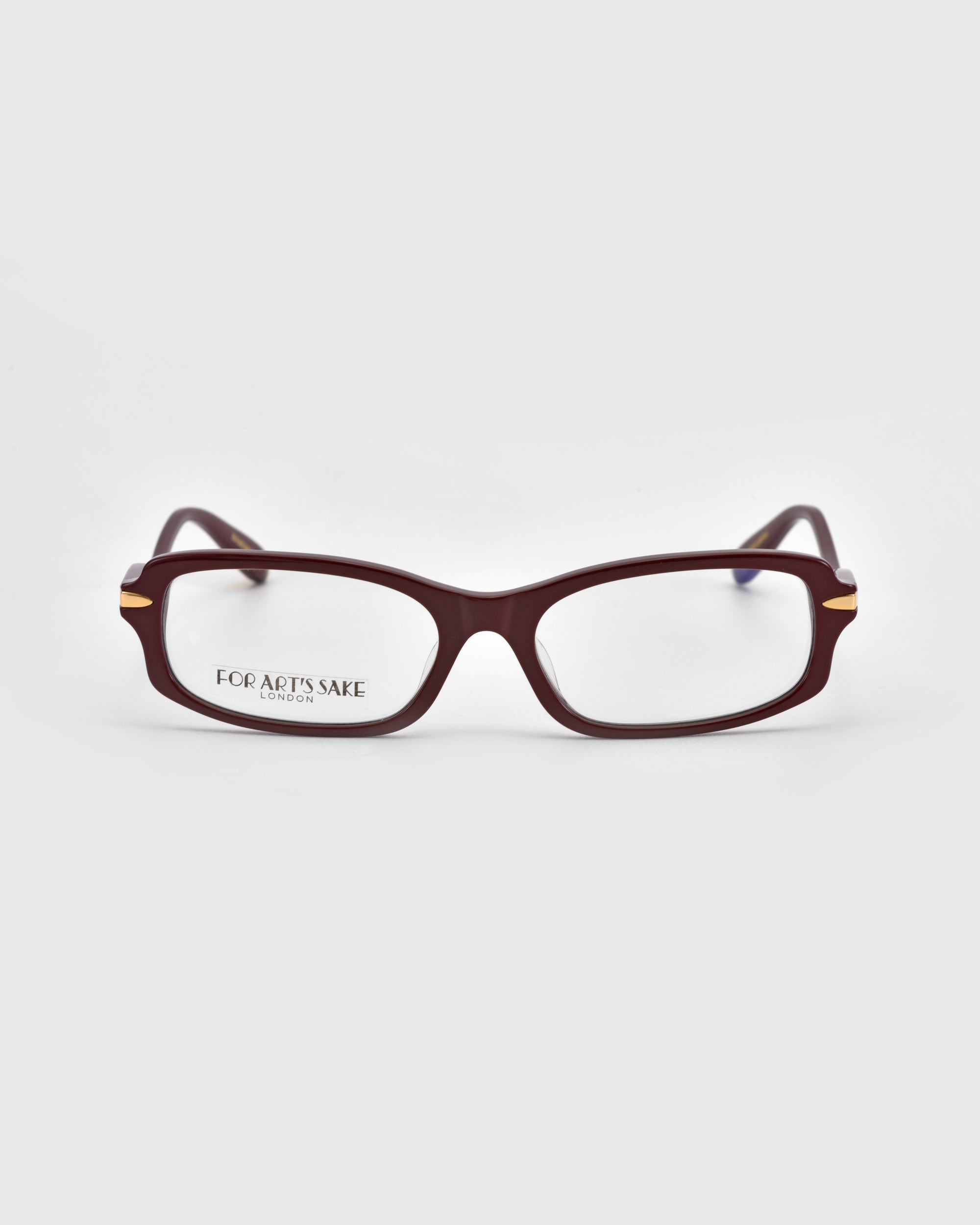 A pair of For Art's Sake® Motion II dark red boxy rectangular eyeglasses with clear lenses, curved acetate temples, and gold metal hinge accents is displayed on a plain light gray background. The left lens reads "For Art’s Sake London.