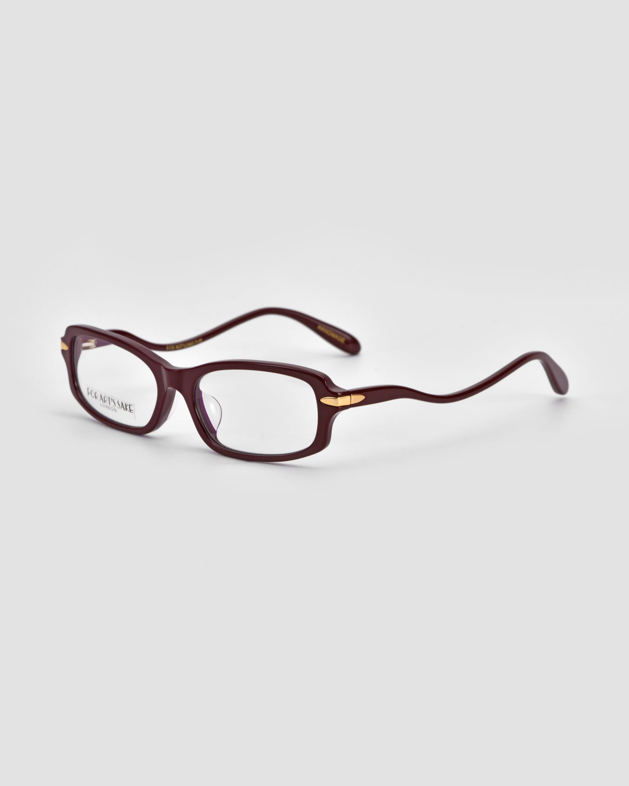 The For Art’s Sake® Motion II sunglasses feature a boxy rectangular shape in dark red, gold metal hinge accents, and curved acetate temples, shown on a light grey background.