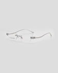 The For Art's Sake® Ida is a chic pair of rimless cat-eye glasses featuring thin silver metal arms and stylish floral accents at the corners, offering a lightweight and uniquely floral eyeglasses design.